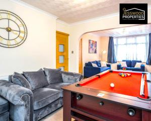 a living room with a couch and a pool table at Large 6 Bedroom Contractor House by Jesswood Properties Short Lets For Groups, Business And Leisure With Free Parking, Wifi and Pool Table in Luton