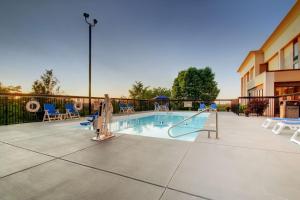 a swimming pool with a slide and chairs at Hampton Inn Rolla in Rolla