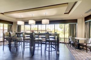 a dining room with a table and chairs and windows at Hampton Inn Rolla in Rolla