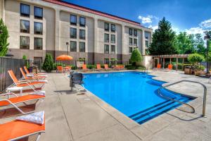 a hotel with a large swimming pool in front of a building at Hampton Inn Rocky Mount in Rocky Mount