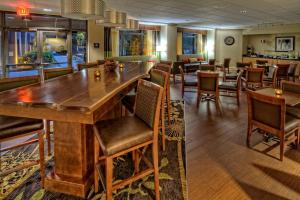 a dining room with a large wooden table and chairs at Hampton Inn Rocky Mount in Rocky Mount