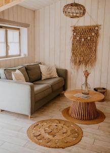 sala de estar con sofá y mesa en La cabane de Mamie classée 4 étoiles à 150m de la plage 2 chambres 3 lits, en Biscarrosse