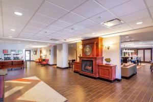 a lobby with a fireplace in the middle of a building at Hampton Inn Rawlins in Rawlins