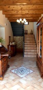 a living room with a staircase and a rug on the floor at Luci nel Bosco B&B in Montalto