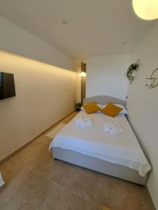 a bedroom with a large white bed with orange pillows at Apartment Melany in Senj