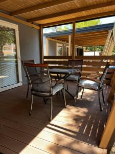 a patio with chairs and a table on a deck at Lily B in Pakoštane
