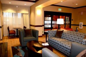 a living room with a couch and chairs and a table at Hampton Inn & Suites Folsom in Folsom +79 photos