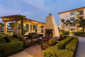 a patio with a fireplace and chairs and a building at Homewood Suites by Hilton San Diego Airport-Liberty Station in San Diego