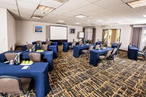 a conference room with blue tables and chairs and a whiteboard at Homewood Suites by Hilton San Diego Airport-Liberty Station in San Diego