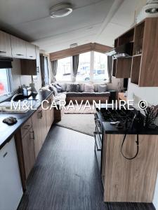 a kitchen and living room of a motorhome at Blue Dolphin Holiday Park in Gristhorpe
