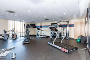 a gym with several treadmills and elliptical machines at Hampton Inn & Suites Pittsburg in Pittsburg