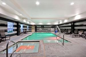 a pool in a building with chairs and a swimming pool at Hampton Inn & Suites San Antonio/Northeast I-35 in San Antonio