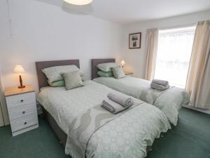 a bedroom with two beds with towels on them at Nook Farm Holiday Cottage in Sheffield