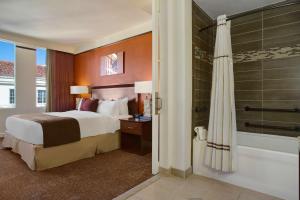 a hotel room with a bed and a shower at The Emily Morgan Hotel - A DoubleTree by Hilton in San Antonio