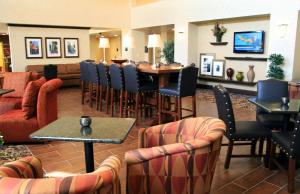 a hotel lobby with a restaurant with a table and chairs at Hampton Inn & Suites Lodi in Lodi