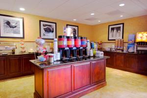 a restaurant with a counter with a bunch of food at Hampton Inn & Suites Lodi in Lodi