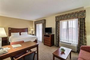 a hotel room with a bed and a desk at Hampton Inn & Suites Savannah - I-95 South - Gateway in Savannah