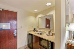 a bathroom with a sink and a mirror at Hampton Inn & Suites Savannah - I-95 South - Gateway in Savannah