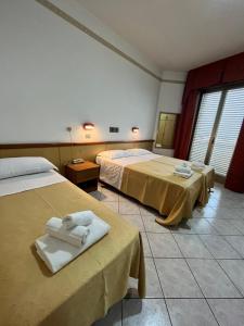 Postel nebo postele na pokoji v ubytování Hotel Columbia Frontemare