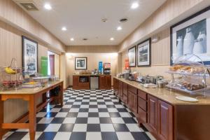 a large kitchen with black and white checkered floor at Hampton Inn Goshen in Goshen