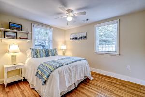 a bedroom with a bed and two windows at Live Like a Local in Charleston