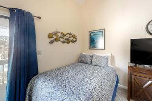 a bedroom with a bed and a flat screen tv at Golf Colony at Deerfield 26H in Myrtle Beach
