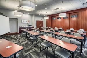 a classroom with tables and chairs and a chalkboard at Hampton Inn Louisville Northeast in Louisville +37 photos