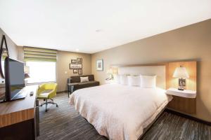 a hotel room with a bed and a desk and a television at Hampton Inn & Suites Seattle-Downtown in Seattle