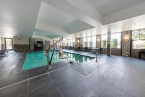 a swimming pool in a large building with a pool at Hampton Inn & Suites DuPont in DuPont