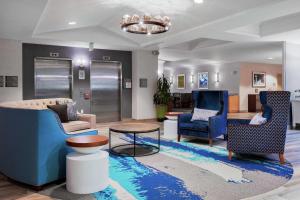 a lobby with chairs and a couch and a table at Homewood Suites by Hilton Seattle Downtown in Seattle
