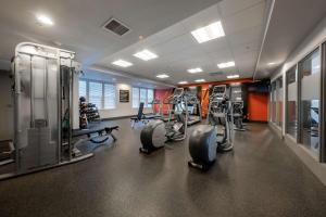 a gym with several treadmills and elliptical machines at Hampton Inn & Suites DuPont in DuPont