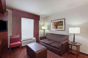 a living room with a couch and a chair at Hampton Inn and Suites Seattle - Airport / 28th Avenue in SeaTac