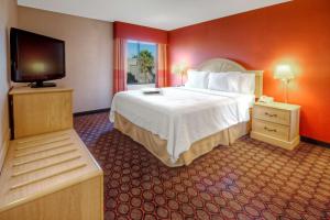 a hotel room with a bed and a flat screen tv at Hampton Inn Fremont in Fremont +39 photos