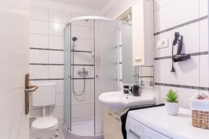 a bathroom with a shower and a toilet and a sink at Apartman Marija in Zagreb