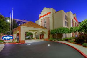 a hotel building with a sign in front of it at Hampton Inn Milpitas in Milpitas