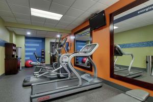 a gym with several tread machines and a mirror at Hampton Inn Lebanon in Lebanon