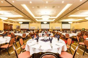 a banquet hall with white tables and chairs at Hilton Garden Inn St. George in St. George