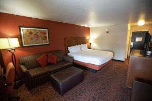 a hotel room with a bed and a couch at Hampton Inn St. George in St. George