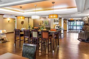 a dining room and kitchen with a table and chairs at Hampton Inn South Hill in South Hill