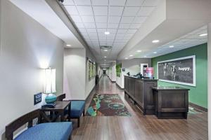 a hallway of a hospital with a waiting room with chairs and a desk at Hampton Inn & Suites Shreveport/Bossier City at Airline Drive in Bossier City