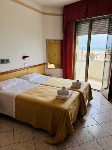 Postel nebo postele na pokoji v ubytování Hotel Columbia Frontemare