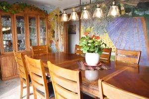 a dining room with a wooden table with a potted plant at As You Like It Bed and Breakfast in Niagara on the Lake