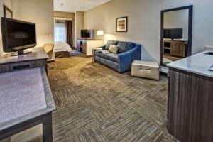 a hotel room with a couch and a television at Hampton Inn Salt Lake City-Layton in Layton