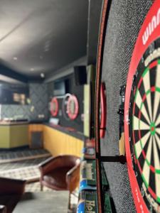 a dart board on a wall in a room at Rooms Kingswood in Bristol