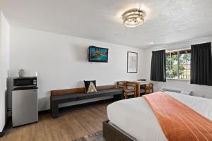 a hotel room with a bed and a couch at Broken Spur Inn & Steakhouse in Torrey +84 photos