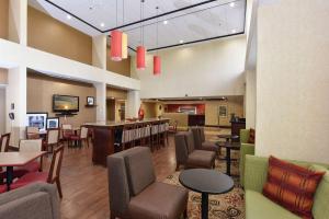 a lobby with a bar and tables and chairs at Hampton Inn Selma in Selma