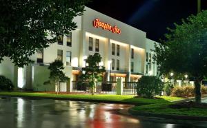 a building with a neon sign on the side of it at Hampton Inn Santee-I-95 in Santee