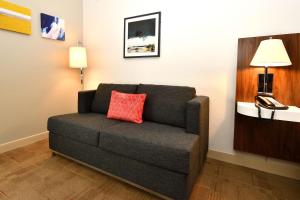 a couch with a red pillow in a room at Hampton Inn Santee-I-95 in Santee