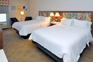 a hotel room with two beds and a television at Hampton Inn Santee-I-95 in Santee