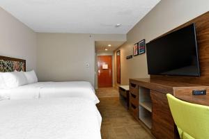 a hotel room with two beds and a flat screen tv at Hampton Inn Santee-I-95 in Santee